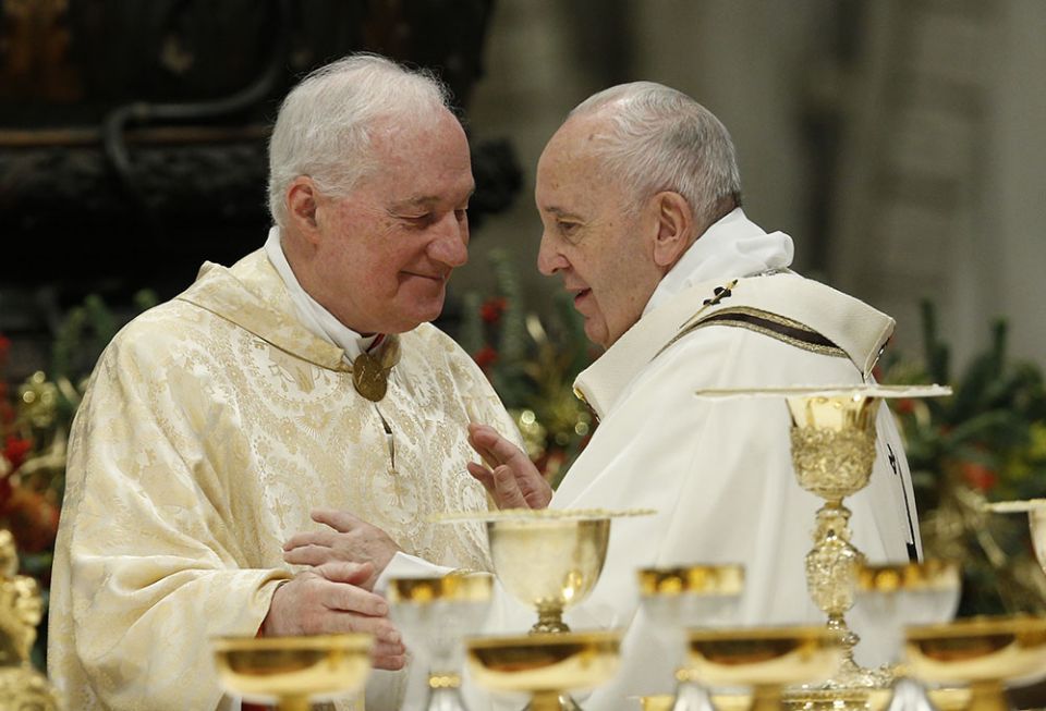 Pope Francis greets Cardinal Marc Ouellet, prefect of the Congregation for Bishops, during the sign of peace as he celebrates Mass marking the feast of the Epiphany in St. Peter's Basilica at the Vatican Jan. 6, 2020. (CNS/Paul Haring)