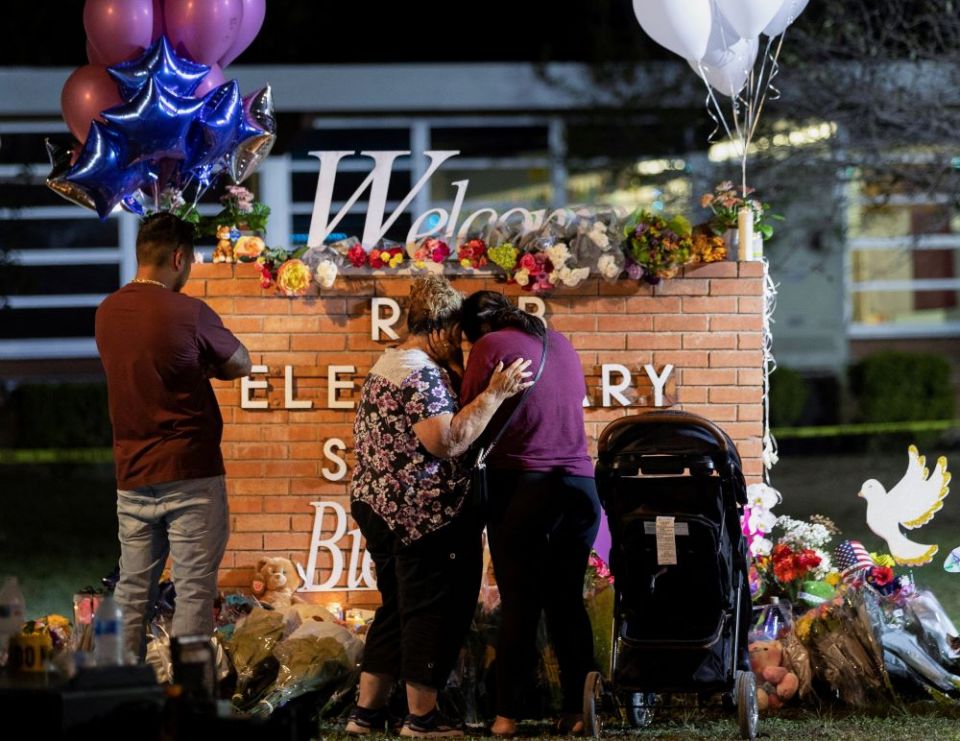 People visit a memorial outside Robb Elementary School in Uvalde, Texas, May 25, the site of a mass shooting. An 18-year-old man shot and killed 19 children and two teachers and injured several more people. (CNS/Reuters/Nuri Vallbona)