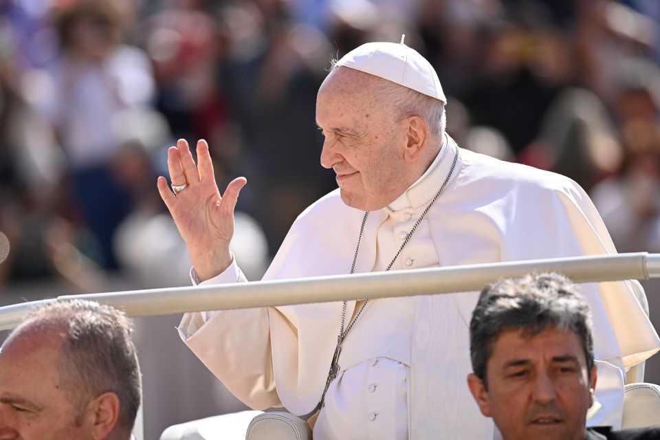 Pope Francis waves to the crowd gathered in St. Peter's Square at the Vatican May 11, 2022, for his weekly general audience. (CNS photo/Vatican Media)