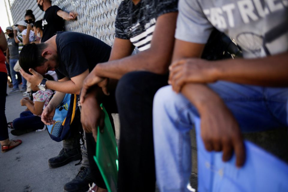 Migrants are seen outside the National Migration Institute in Ciudad Juarez, Mexico, July 8, 2020, where they had to renew their permission to stay in Mexico while awaiting an immigration hearing in the United States. (CNS/Reuters/Jose Luis Gonzalez)