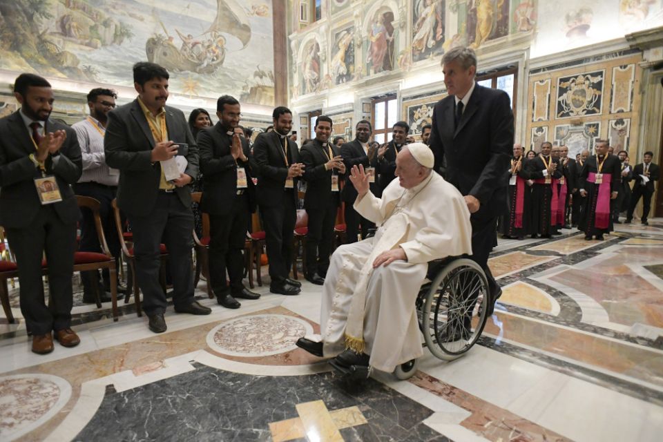 Pope Francis is pushed in a wheelchair by his aide, Sandro Mariotti, during an audience with participants in the Syro-Malabar Youth Leaders Conference, at the Vatican June 18. (CNS/Vatican Media)