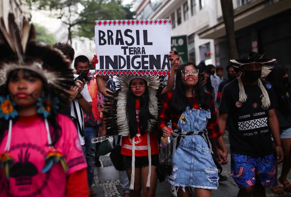 Indigenous people march with a placard that says "Brazil Indigenous Land" as they mark the International Day of the World's Indigenous Peoples in São Paulo Aug. 9. Cardinal Leonardo Steiner said that the Amazon region is seeing an increase in violence.