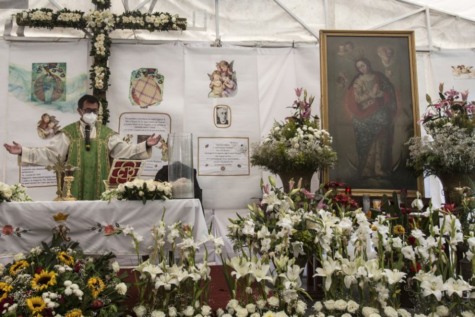 Fr. Adrian Vazquez celebrates an outdoor Mass under a white tent outside the quake-damaged Our Lady of the Angels Church, in the working-class Guerrero neighborhood of Mexico City Aug. 7. (AP/Ginnette Riquelme)